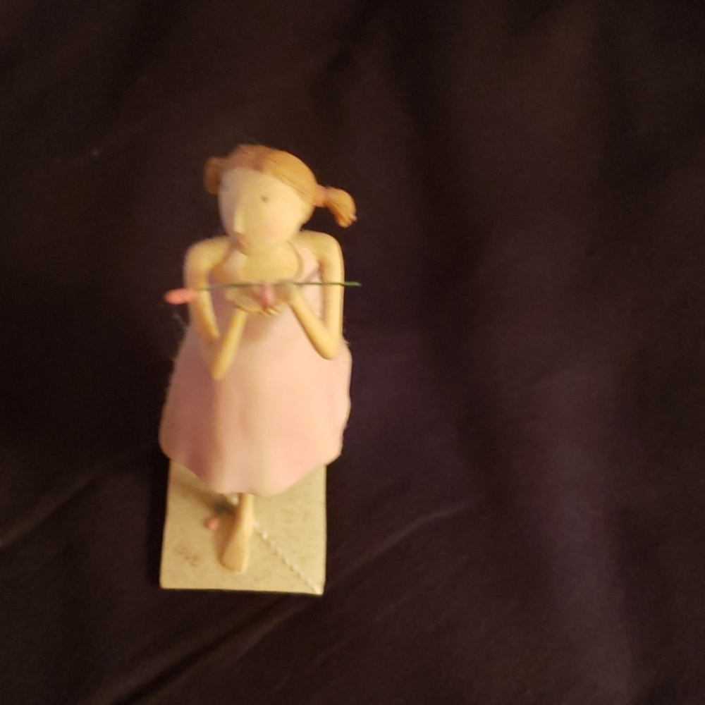 A statue of a girl holding a rose